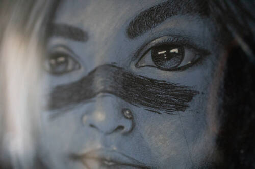 Pencil drawing of a girl with war marks on her face